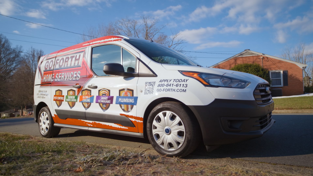 Go-Forth Home Services van showing pest control, termite, and plumbing service badges, parked outside a Piedmont Triad home.