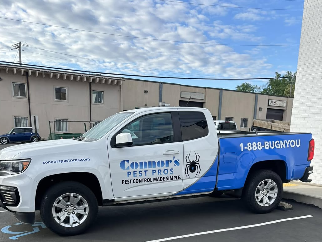 Three branded Connor's Pest Pros service trucks displaying "1-888-BUGNYOU" and "Pest Control Made Simple," with technicians ready for dispatch.